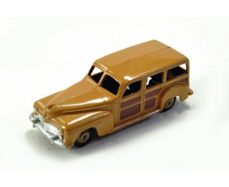 Dinky No. 27f - 344 Plymouth Estate Car with tan body, dark brown side panels, silver trim, fawn ridged hubs with black smoot