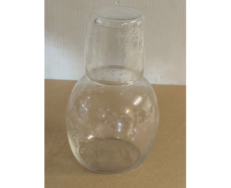 An Edwardian etched glass bedside carafe and glass.