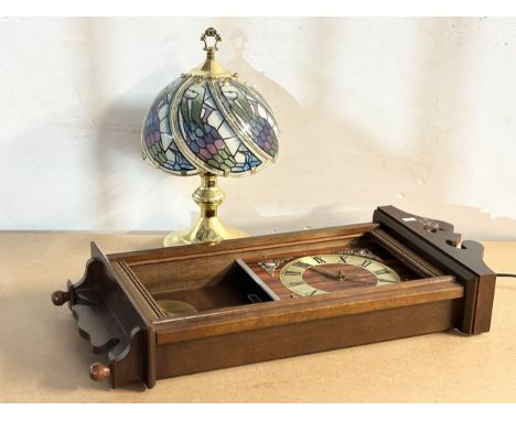 A wall clock and a table lamp.
