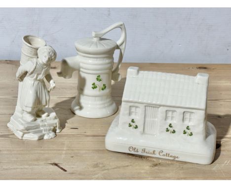 Belleek and Donegal pottery. A Belleek Hawker figurine, Donegal Old Irish Cottage.