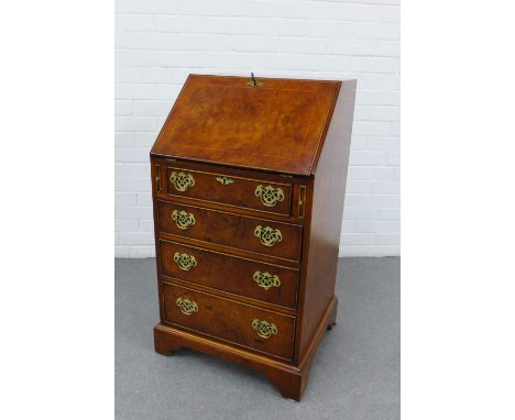 Walnut veneered secretaire chest,the fallfront with a fitted interior over pull slides, with four graduated long drawers, orn