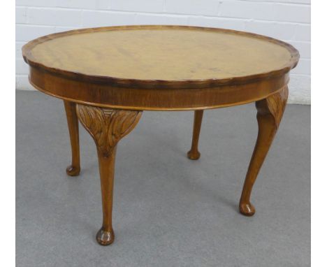 Walnut occasional table, the ova pie crust top on carved cabriole legs, 44 x 70cm 