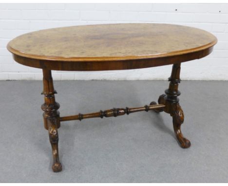 Burr wood table, the oval top on twin supports united by a turned stretcher, 60 x 106cm 