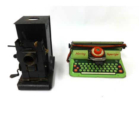 An old tin magic lantern together with a Mettoy typewriter, boxed.
