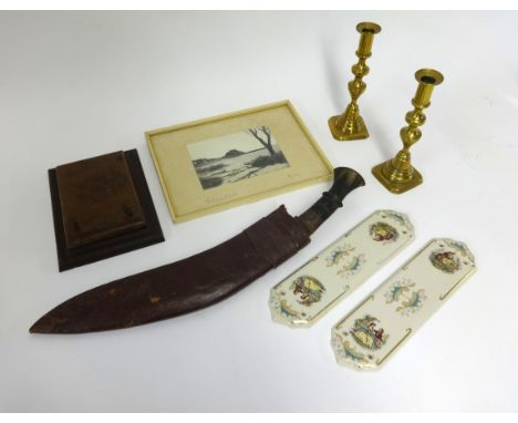 A large kukri knife with horn handle, leather scabbard (worn), three piece enamelled condiment set, a pair of brass candlesti