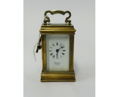 A miniature brass cased carriage clock, the dial marked, 'London' with platform escapement, height 11cm (handle up) with key,