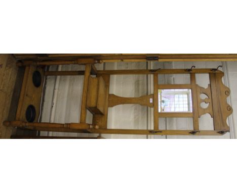 A light oak hall stand with central mirror, six hat hooks, glove box and two stick-trays, 105cm 