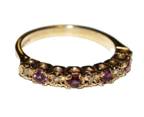 A nine stone ruby and diamond ring set in 9 carat gold