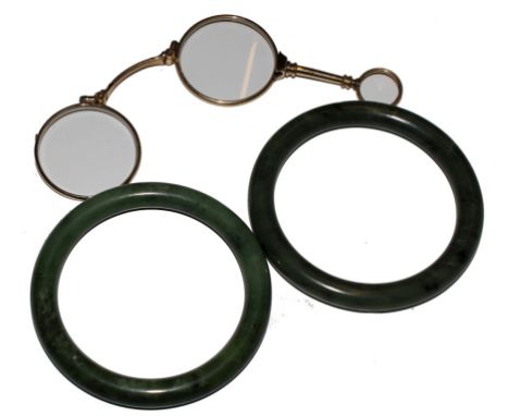 A pair of jade bangles and a pair of lornettes, as found