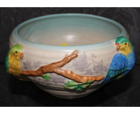 A Clarice Cliff Newport pottery bowl, decorated in relief with budgerigars sitting on a branch, 21cm diameter