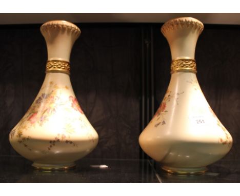 A pair of Royal Worcester pear-shaped ivory ground vases with waisted necks, puce marks