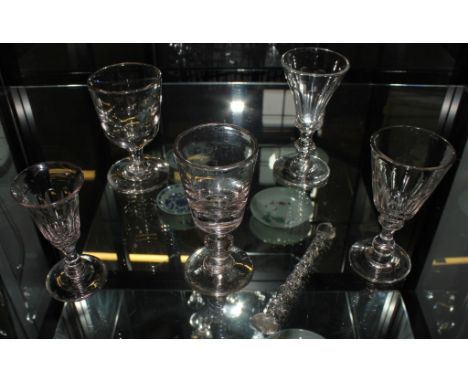 Four 19th century wine glasses, some with knopped and blade-knop stems, a deceptive bowl rummer and a glass barley-twist stir