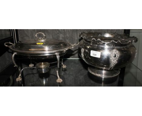 A silver plate entree dish with burner and a planter