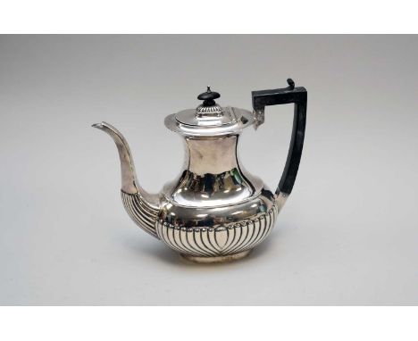A silver coffee pot, Williams (Birmingham) Ltd, Birmingham 1912, of half reeded form with ebonised handle and finial, 23cm hi