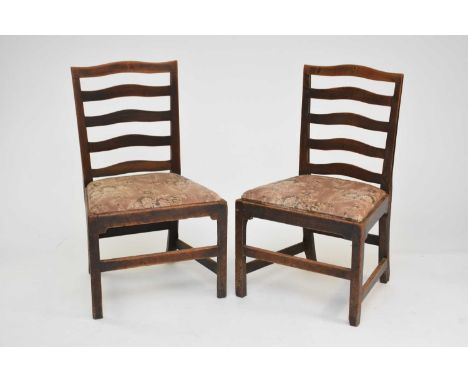 A pair of fruitwood ladder back standard chairs, 19th century, with shaped rails and splats over drop-in seat cushions, seat 