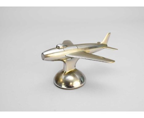 A Dunhill novelty 'Sabre F-86' jet plane table lighter, polished metal on a domed base, 16cm long.