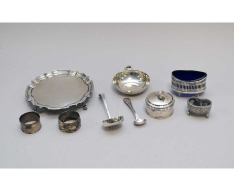 A small collection of silver, comprising; a silver waiter, London 1977, 15.5cm diameter, a pierced oval salt with blue glass 