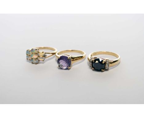 A 9ct gold black and white diamond dress ring, together with a 9ct gold opal cluster ring, a 9ct gold amethyst ring, all size