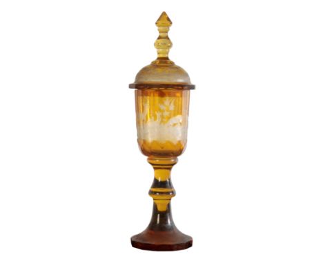 A BOHEMIAN AMBER GLASS GOBLET AND COVER 19th century, the faceted bowl and the cover engraved with deer and stag in woodland 