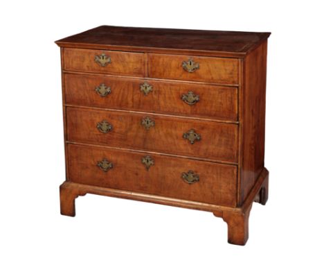 A GEORGE I WALNUT CHEST OF DRAWERS the rectangular quarter veneered top with cross-banding, above two short and three long dr