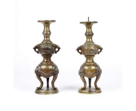 A Pair of Chinese Bronze Twin-Handled Pricket Candlesticks A Pair of Chinese Bronze Twin-Handled Pricket Candlesticks, circa 