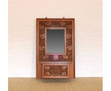 A Late Victorian Oak Wall Mirror A Late Victorian Oak Wall Mirror, with carved fruiting vine motif and candle box with hinged