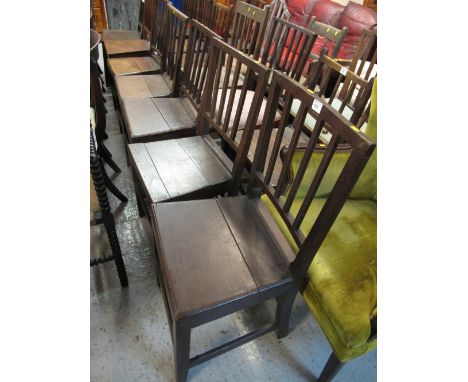 A Harlequin set of eight Welsh oak stick backed dining chairs of slightly differing designs but all with solid seats and squa