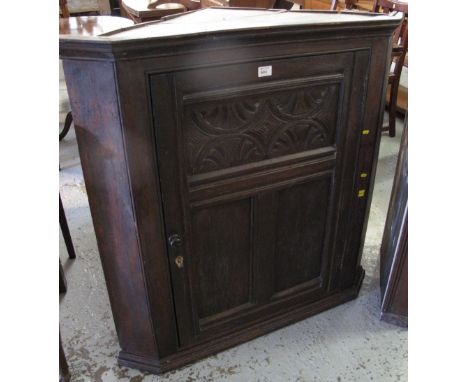 18th Century oak hanging, blind corner cupboard with moulded foliate panel.