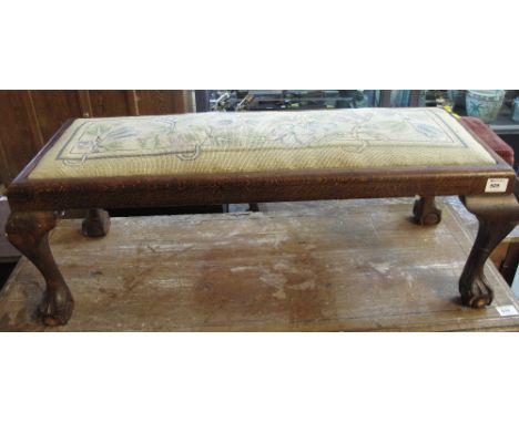 Early 20th Century oak tapestry seated fender stool on cabriole legs with ball and claw feet.
