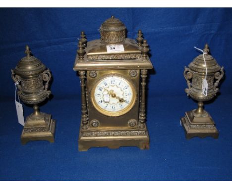 Late 19th Century French brass architectural clock with enamel face and two train brass drum movement, flanked by two vase sh