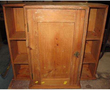 Small natural pine break front blind panel cupboard with side shelves.