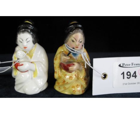 Two similar Royal Worcester bone china candle snuffers in the form of kneeling Chinese ladies.  Printed marks. (2)
