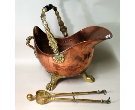 Victorian copper coal bucket, of helmet form on three brass paw feet, the swing and fixed handle moulded with dolphins, also 