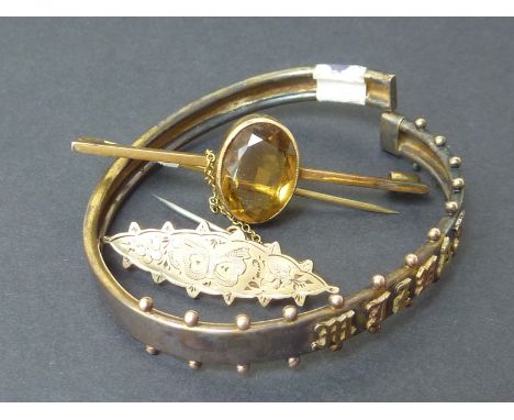 Victorian beaded gold spring bangle, another with Cairngorm and a small 9ct gold brooch (3).