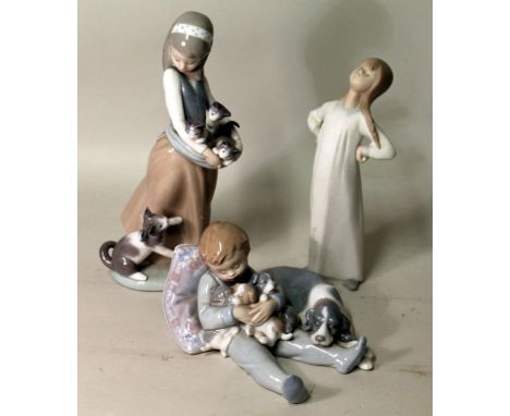 Lladro porcelain figure of a girl with cat and kittens, 24cm high and two others of a dog and puppies, 10cm high, and a girl 