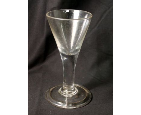 Antique drinking glass, the funnel bowl on drawn plain stem, on domed circular folded foot, 14.5cm high.   Condition Report. 
