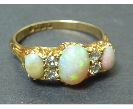 Edwardian 18ct gold ring with two opals and four old cut diamonds, 1907.