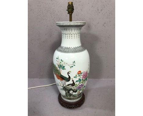 Chinese style ceramic lamp base depicting peacocks, on wooden stand