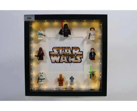 Star Wars - A novelty Star Wars wall clock with Star Wars characters and illumination. This appears to be in mint condition. 
