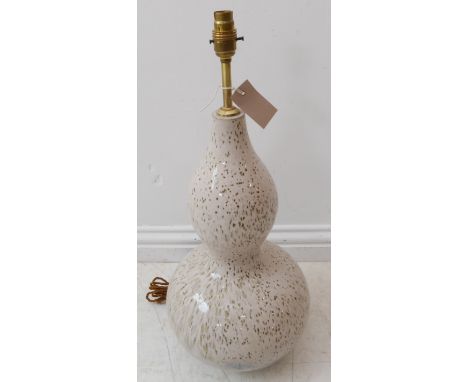 A large glass table lamp of double gourd shape; black speckles against a cream ground (60cm including brass electrical fittin