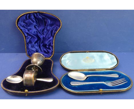 Two cased hallmarked silver sets:1. an egg-cup, spoon and napkin-ring set - the egg cup with maker's mark H&T, assayed Cheste