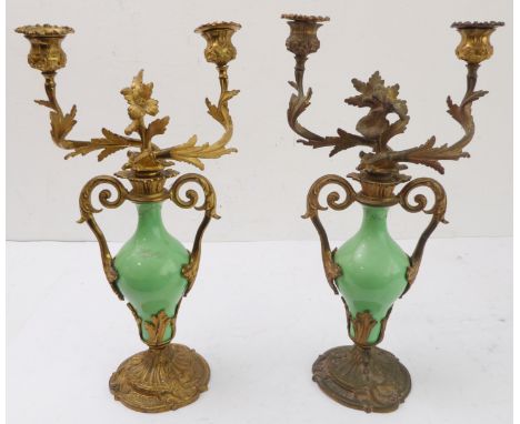 A pair of 19th century gilt-metal-mounted porcelain two-light table candelabra: in the Louis XV taste and with central cast f