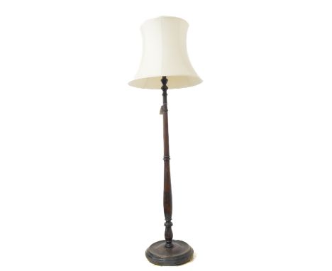 A mid-20th century lamp standard with cream shade - turned stem and circular base (175cm highest including shade)