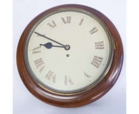 An early 20th century circular mahogany-framed Schoolmaster's style clock; cream dial with Roman numerals, together with key 