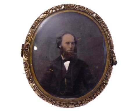A 19th century oval portrait miniature; the finely cast oval gilt metal frame surrounding a half length portrait of a Victori