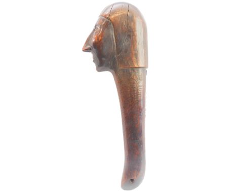 An early 20th century hardwood war club in the Iroquois style. Well-patinated, the terminal modelled as an elongated male fac