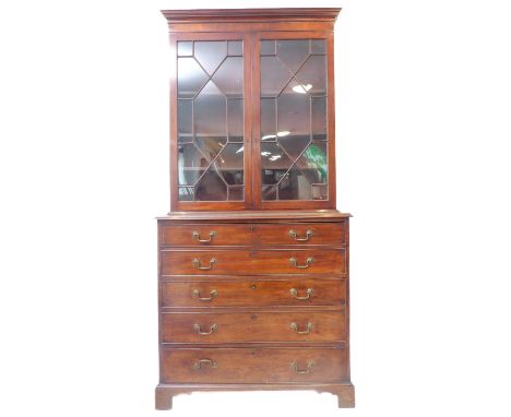 A fine and large mid/late 18th century mahogany secretaire bookcase; the outset cornice above two thirteen panel glazed doors