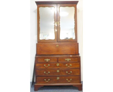 &nbsp;A tall mahogany mirror fronted cabinet (made up from three pieces of 18th century furniture); the dentil cornice above 