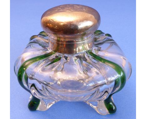 A late 19th century clear-glass inkwell of squat ovoid form -  four green glass highlights trailing to the feet, the silver h