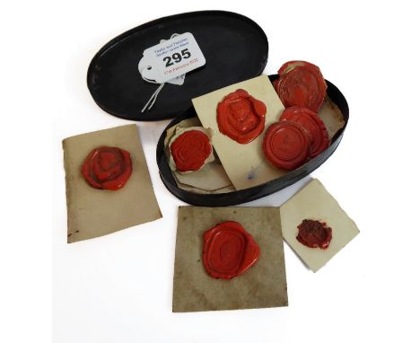 A George III period ebonised tin snuff box containing various red seals. The box&nbsp;of oval from with its lid decorated wit